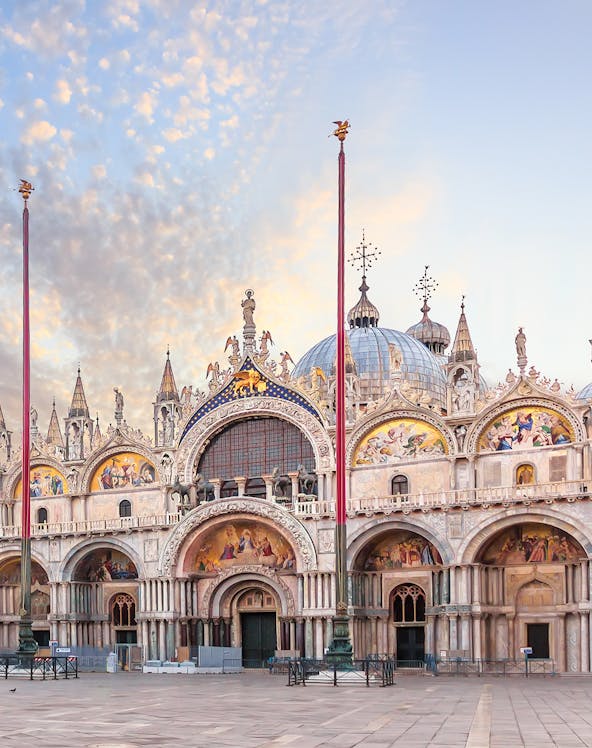 St. Mark's Basilica facade in Venice with ornate architecture and detailed mosaics.