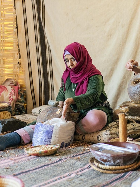 Women producing argan oil using traditional methods in Essaouira, Morocco.