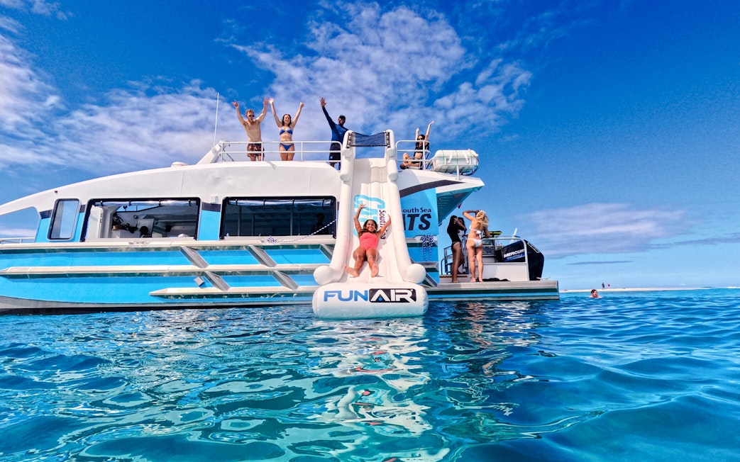 Woman sliding from Ride and Slide Catamaran in Fiji's South Sea Cats.