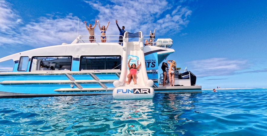 Woman sliding from Ride and Slide Catamaran in Fiji's South Sea Cats.