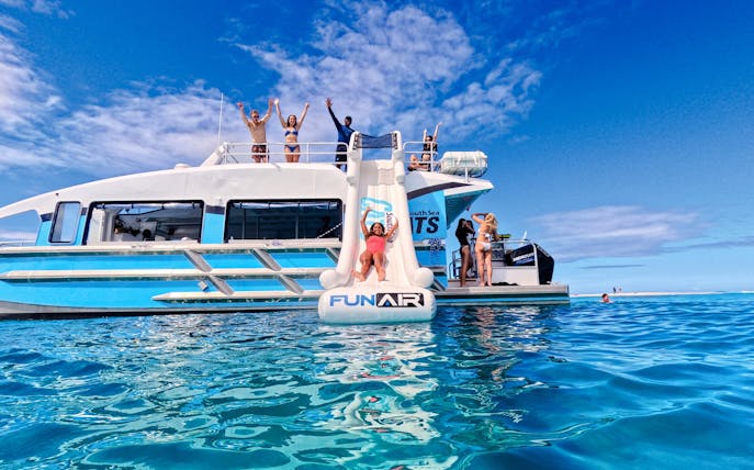 Woman sliding from Ride and Slide Catamaran in Fiji's South Sea Cats.