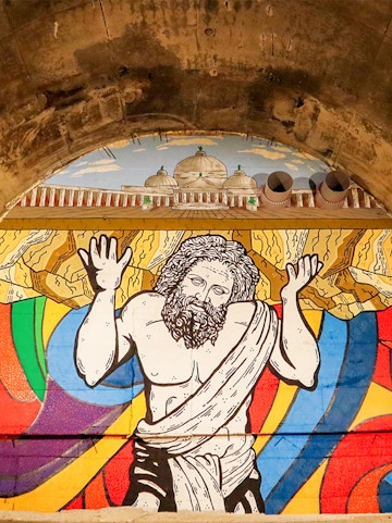 Mural of Atlas holding up the world in Bourbon Tunnel, Naples.