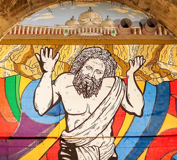 Mural of Atlas holding up the world in Bourbon Tunnel, Naples.