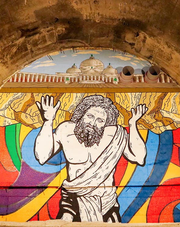 Mural of Atlas holding up the world in Bourbon Tunnel, Naples.