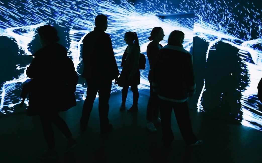 Visitors exploring digital art installation at Lift 109, Battersea Power Station.