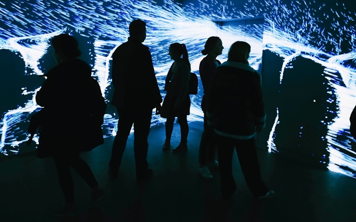 Visitors exploring digital art installation at Lift 109, Battersea Power Station.