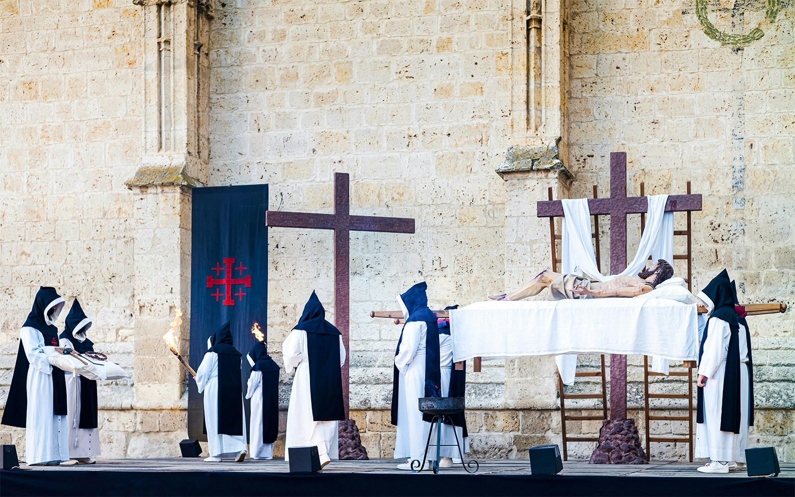 Easter Week procession in Florence with participants carrying a statue of Christ.