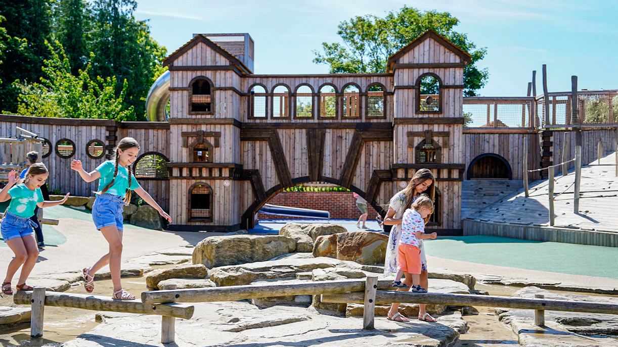 Children playing on wooden beams at the adventure play area, Blenheim Palace.