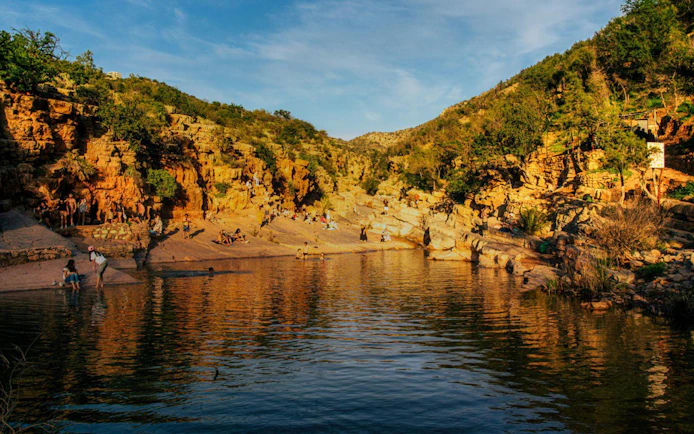 Visitors enjoying the natural rock pools and scenic views at Paradise Valley.