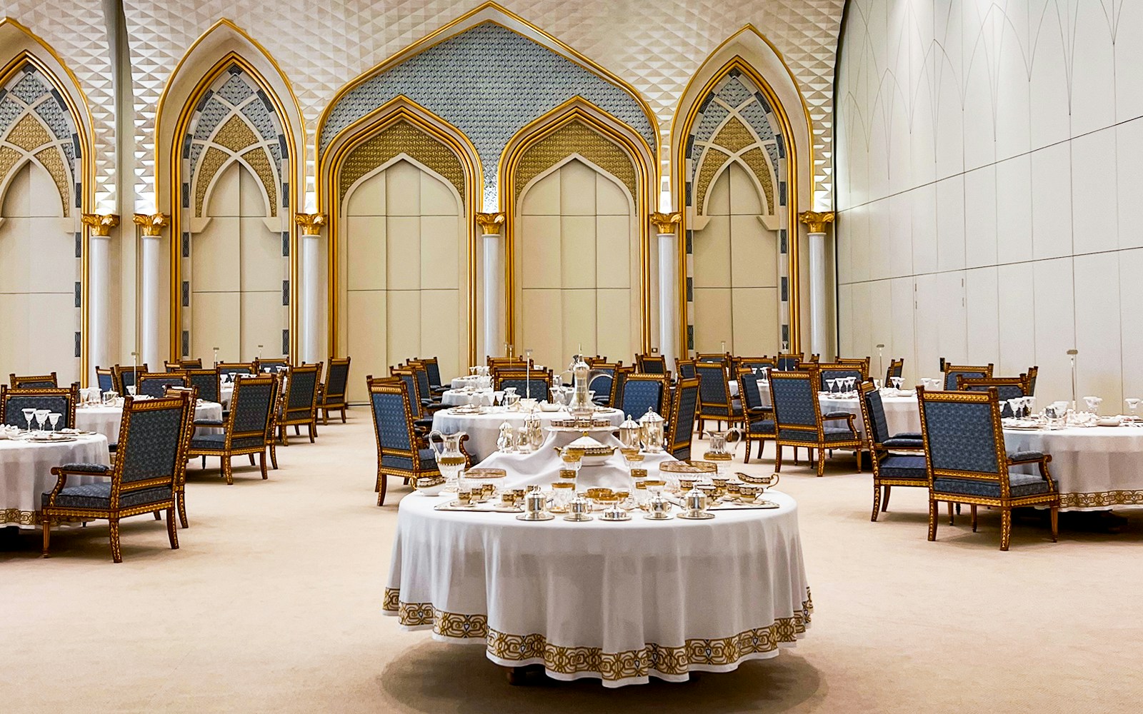 Presidential Banquet Hall in Dubai with blue chairs and set dining tables.