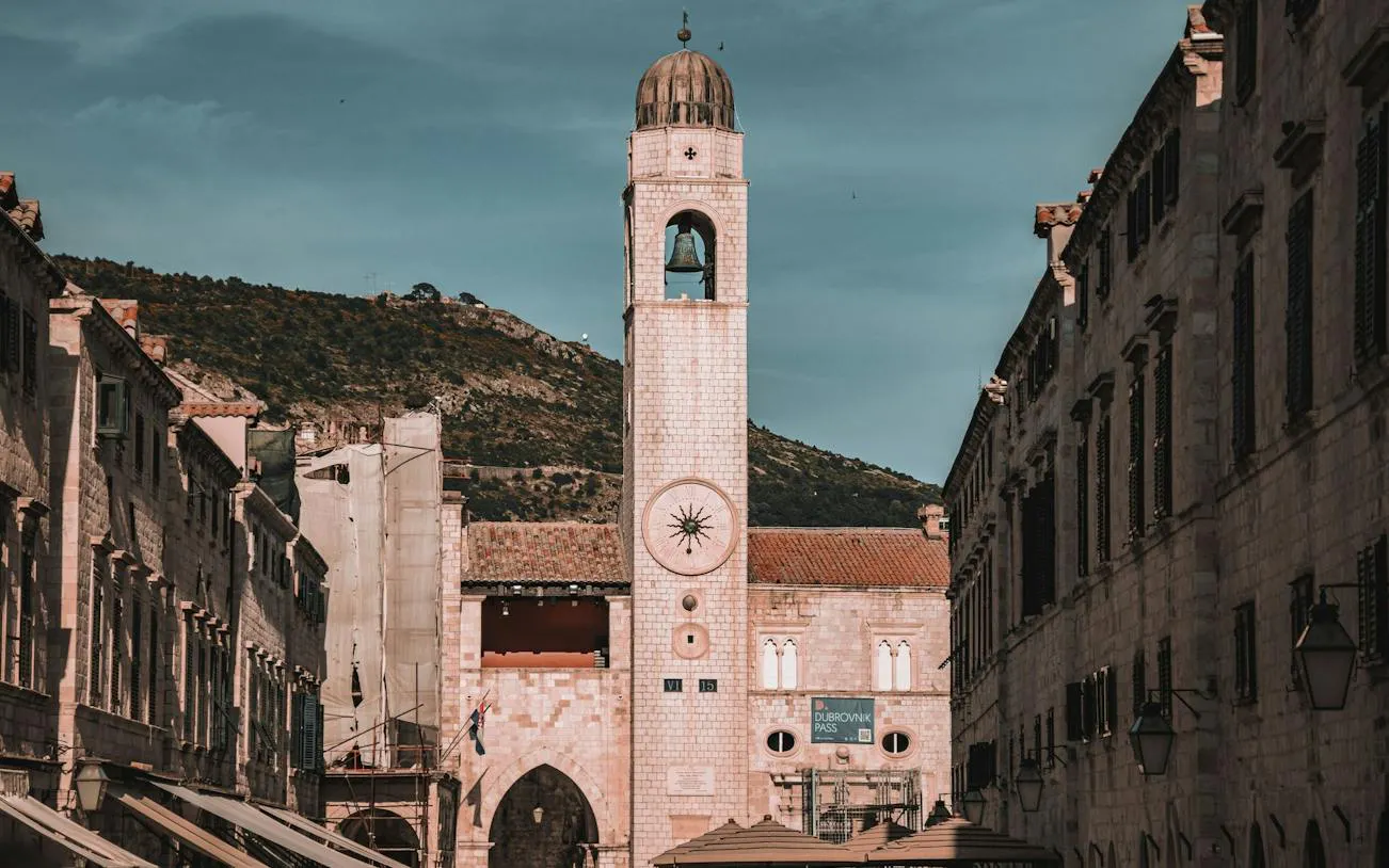 Clock tower on Stradun street in Dubrovnik Old Town, view towards Jesuit Stairs.