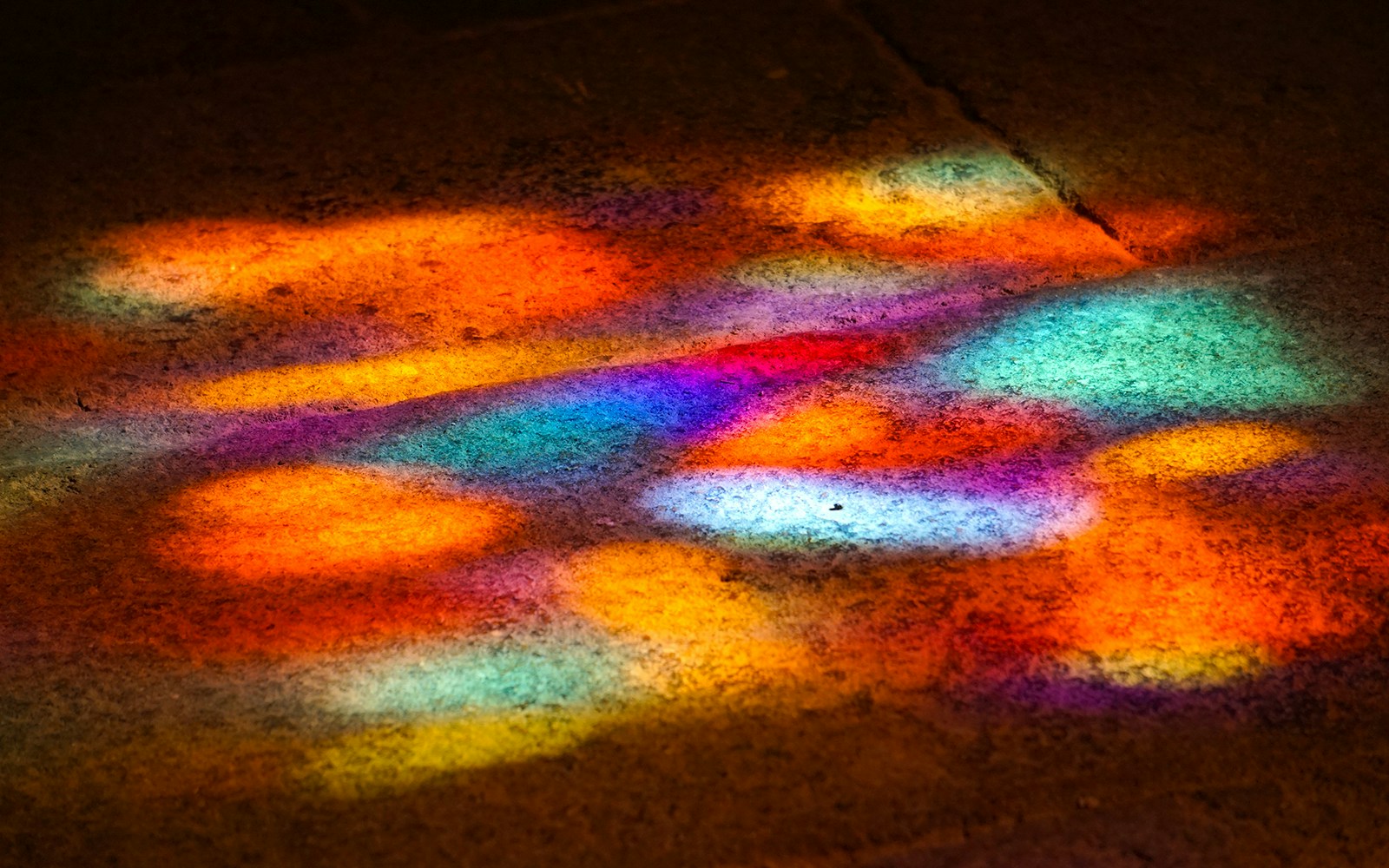 Saint Chapelle stained glass reflection creating kaleidoscope effect with light play in Paris, France.