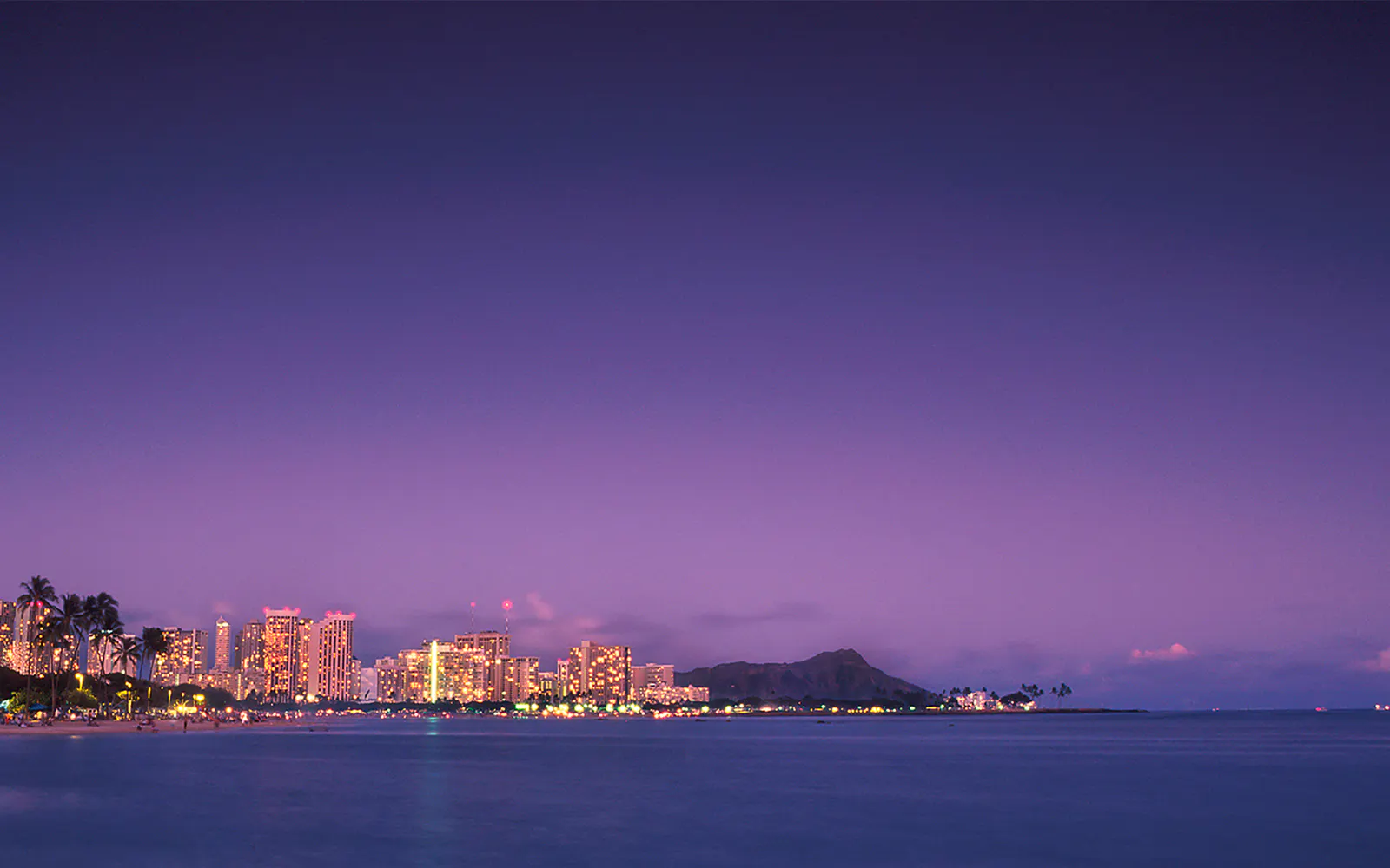 Honolulu skyline at dusk with Diamond Head in view, Hawaii.