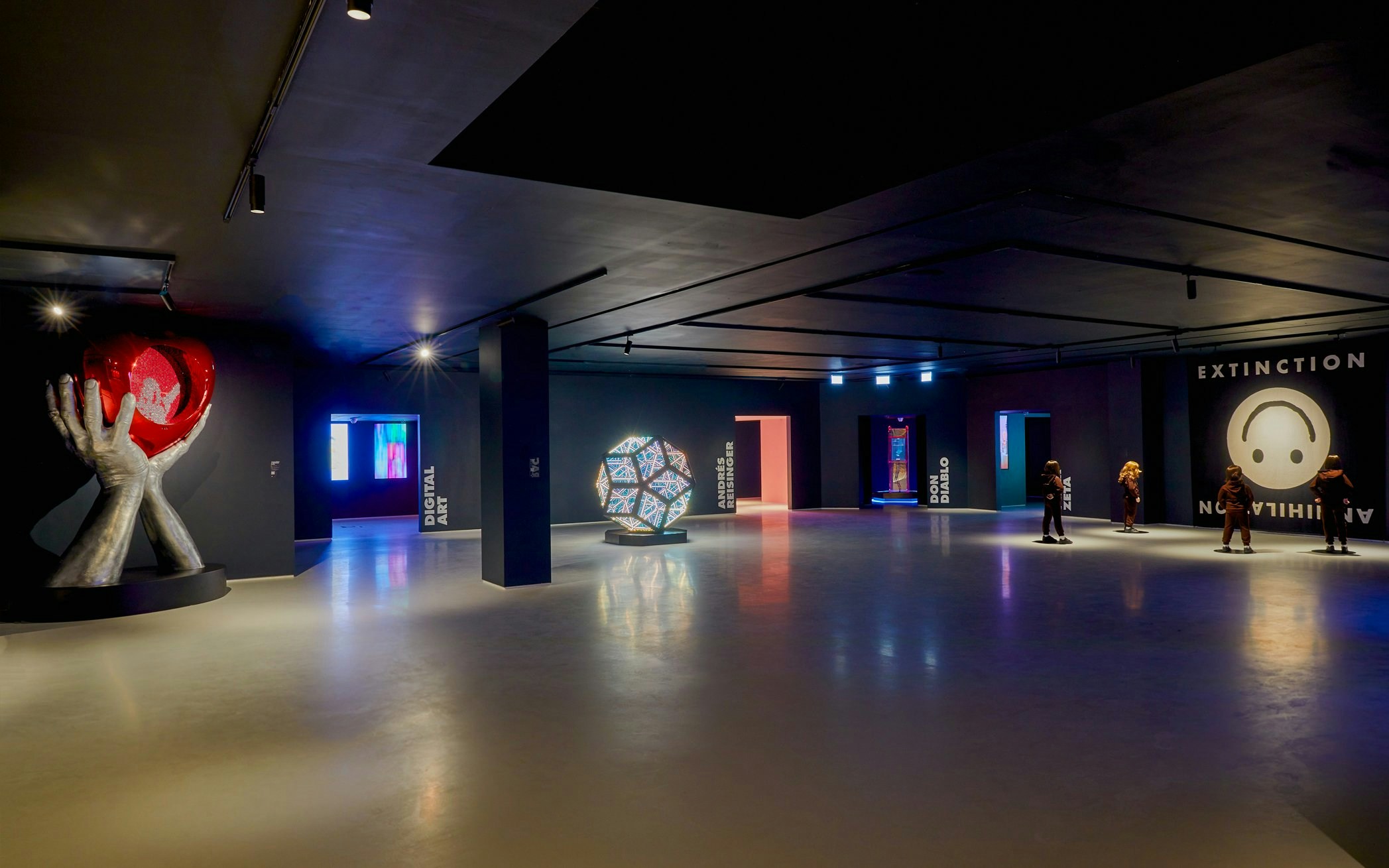 Moco Museum London interior with modern art installations and visitors exploring exhibits.