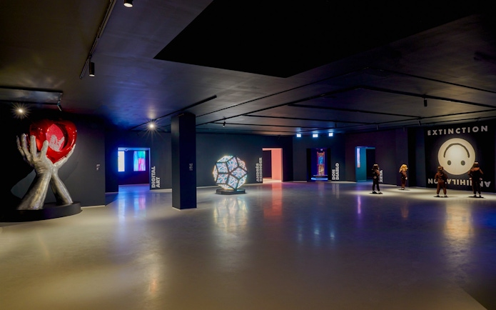 Moco Museum London interior with modern art installations and visitors exploring exhibits.