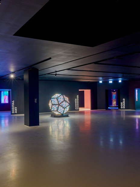 Moco Museum London interior with modern art installations and visitors exploring exhibits.