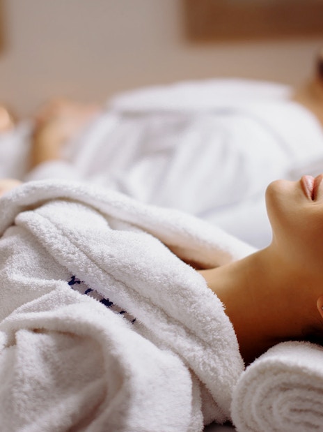 Couple receiving head massages at Spa in Therme Bucuresti.