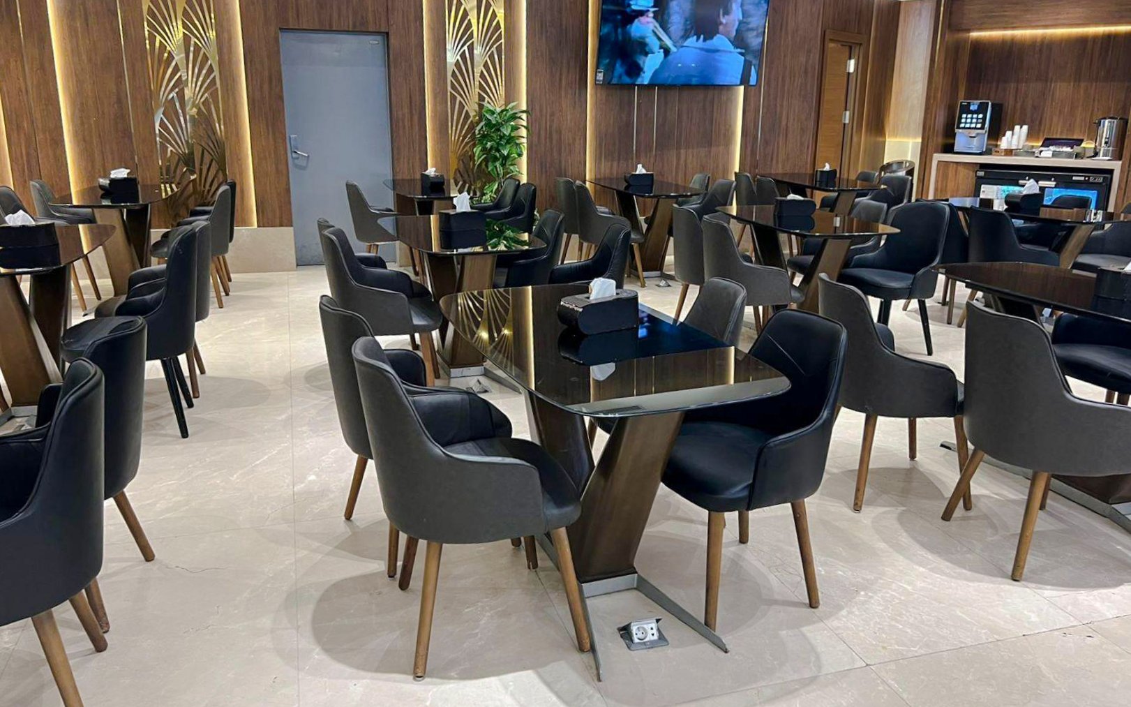 Dining area with modern seating at Plaza Premium Lounge, Cairo.