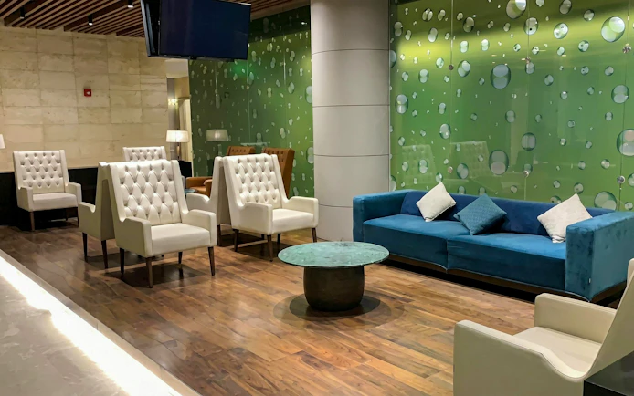 Primeclass Lounge seating area at Muscat International Airport departures.
