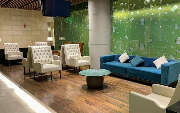 Primeclass Lounge seating area at Muscat International Airport departures.