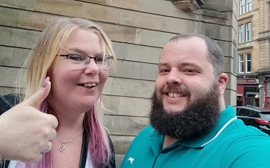 Self-guided city exploration in historic Glasgow with smiling participants.