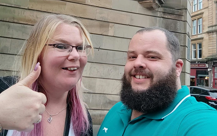 Self-guided city exploration in historic Glasgow with smiling participants.
