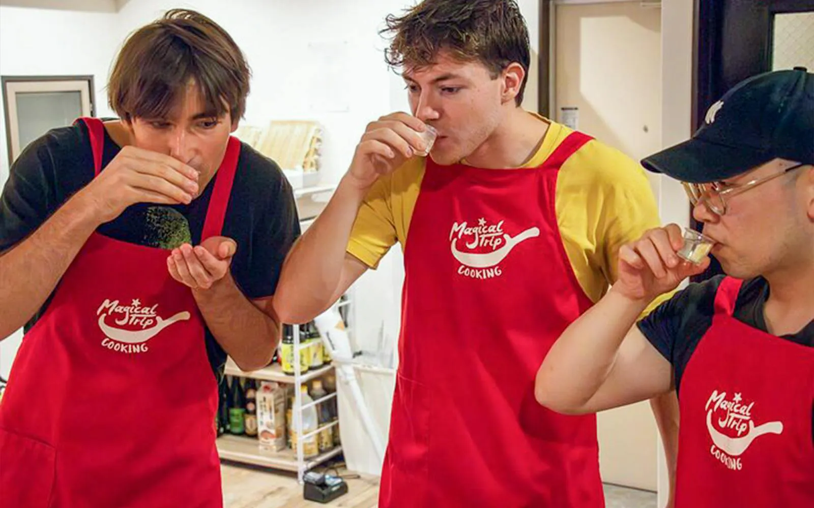 Participants tasting drinks during Tokyo Izakaya-style cooking class.