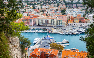 Nice harbor view with colorful buildings and yachts, ideal for a self-guided audio tour.