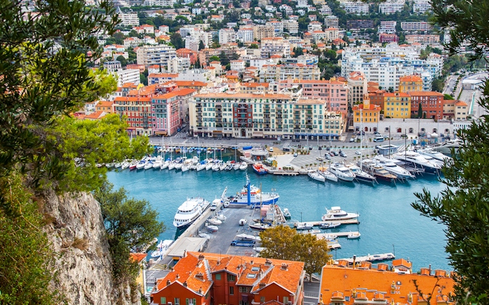 Nice harbor view with colorful buildings and yachts, ideal for a self-guided audio tour.