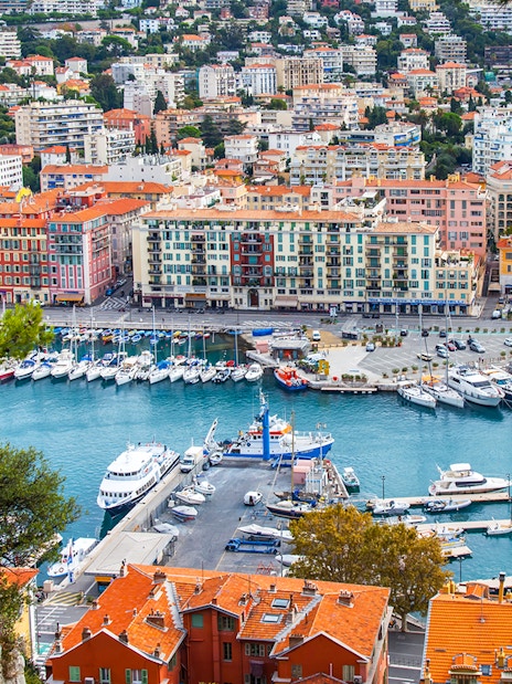 Nice harbor view with colorful buildings and yachts, ideal for a self-guided audio tour.