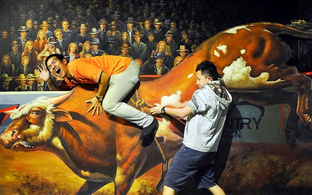 Visitors interacting with a 3D bull artwork at Alive 3D Art Gallery, Port Dickson.