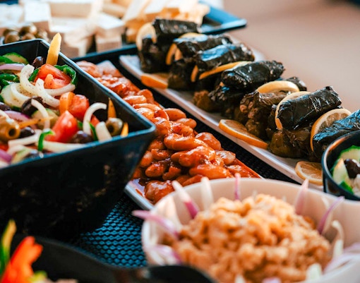 Assorted Greek dishes served on a Santorini luxury catamaran cruise.