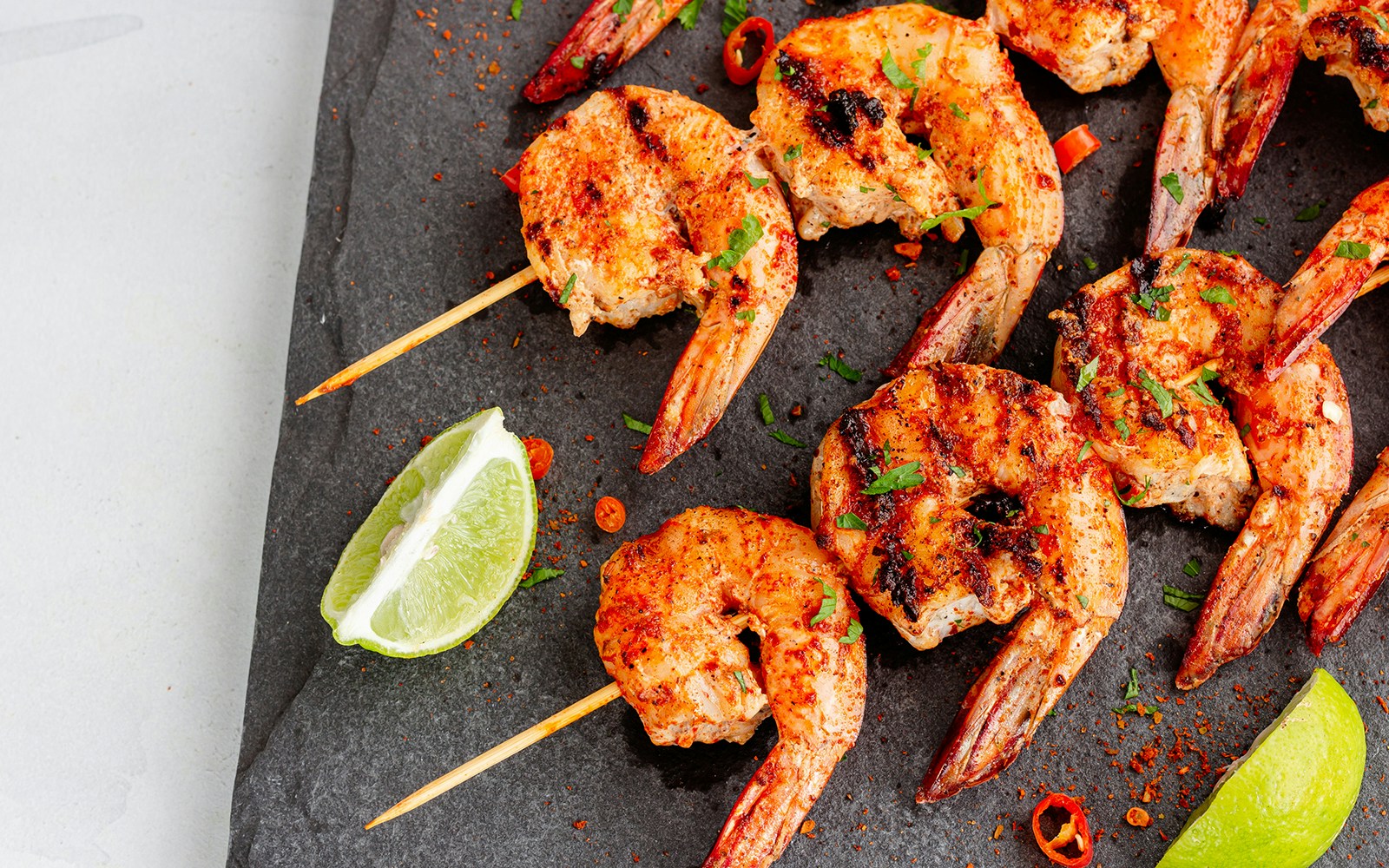 Grilled prawns with Belem Tower in Lisbon, Portugal in the background.
