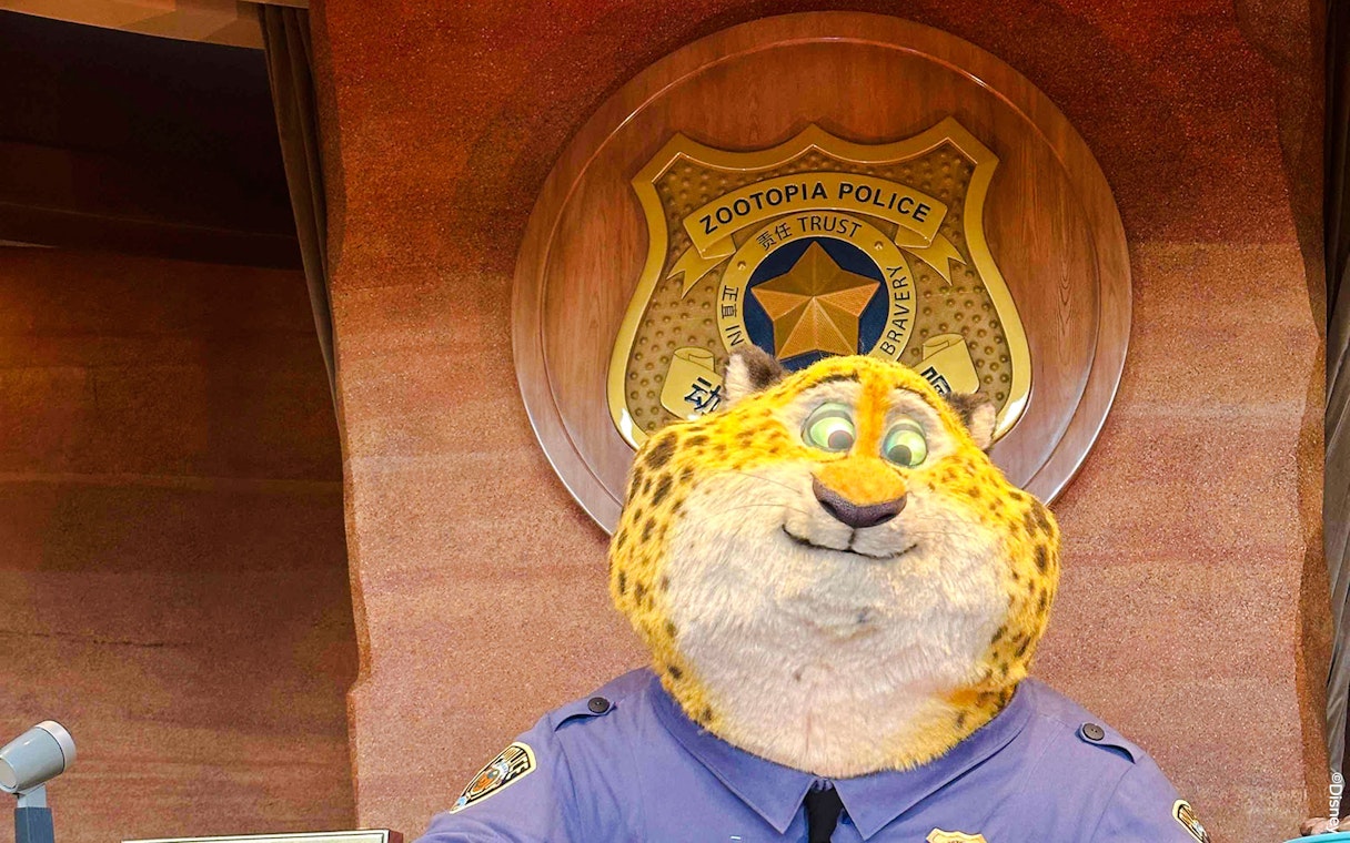 Zootopia police officer character in front of police badge emblem.