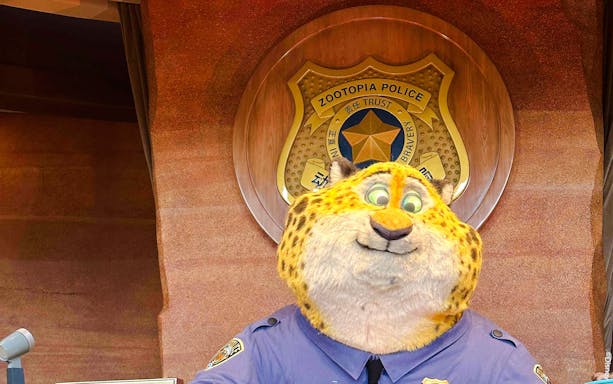 Zootopia police officer character in front of police badge emblem.