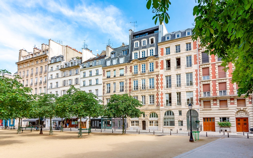 Historic buildings and trees in a square on Île de la Cité, Paris.