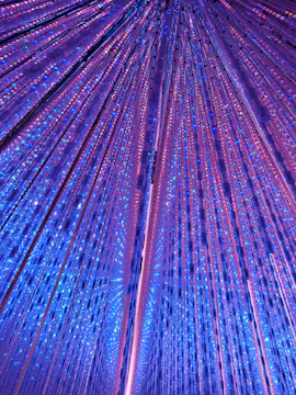 Interactive light installation at TeamLab Planets Tokyo with vibrant blue and purple lights.