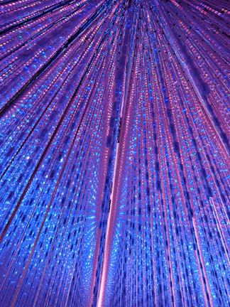 Interactive light installation at TeamLab Planets Tokyo with vibrant blue and purple lights.