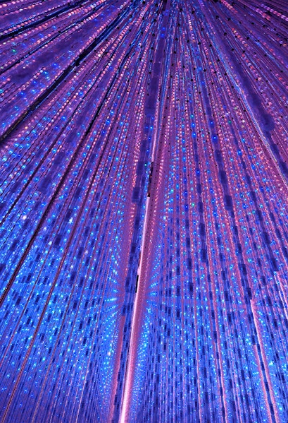 Interactive light installation at TeamLab Planets Tokyo with vibrant blue and purple lights.