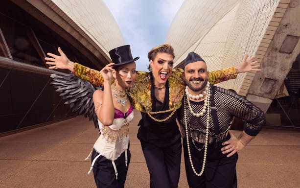 Performers in costume outside the Sydney Opera House for an opera event.