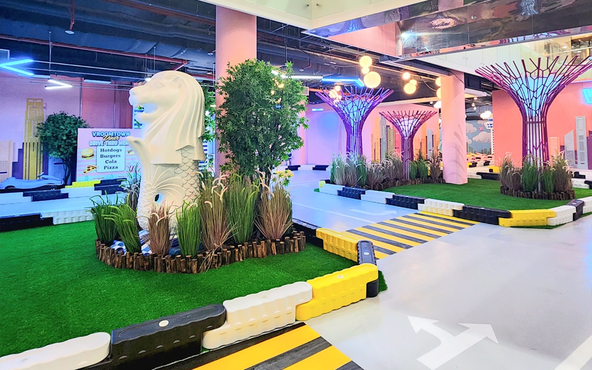 Miniature Merlion statue at VroomTown Driving City indoor track.