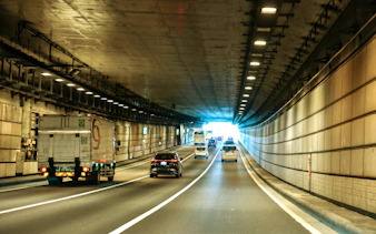 Cars driving through a tunnel in Tokyo, Japan, heading towards Daikoku PA.