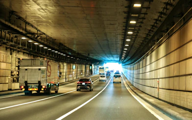 Cars driving through a tunnel in Tokyo, Japan, heading towards Daikoku PA.
