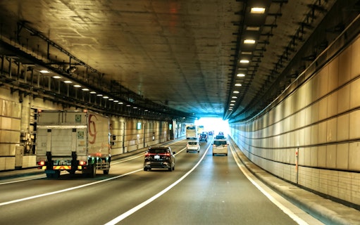Cars driving through a tunnel in Tokyo, Japan, heading towards Daikoku PA.