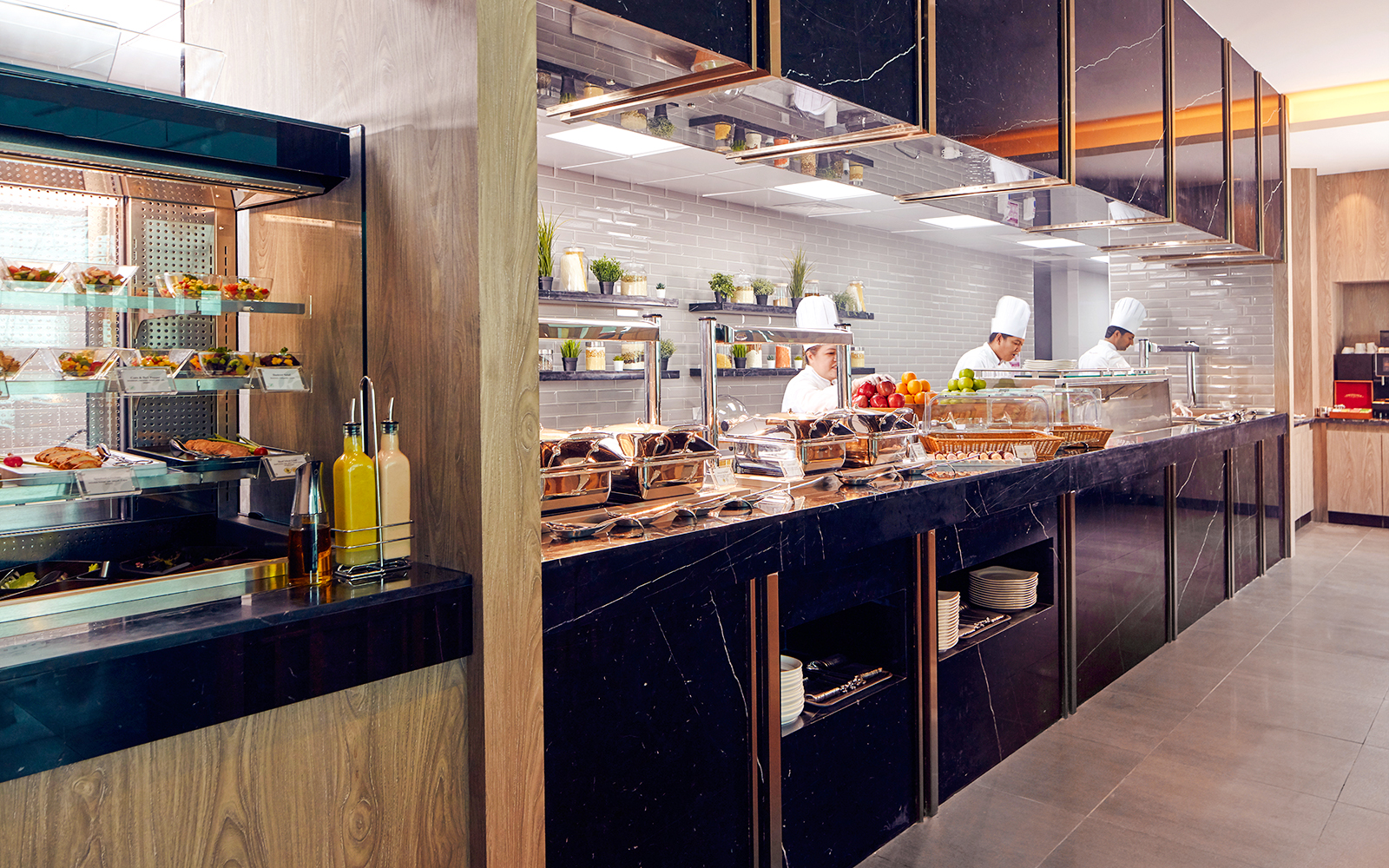 Chefs preparing food at Plaza Premium Lounge, Dubai International Airport.