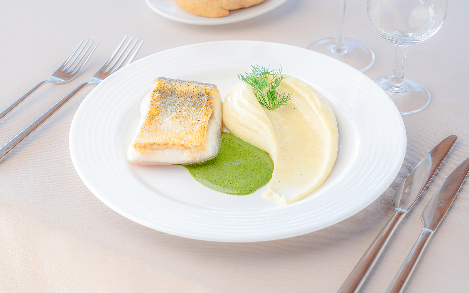 Grilled fish with mashed potatoes and green sauce served on a Seine River sightseeing cruise.