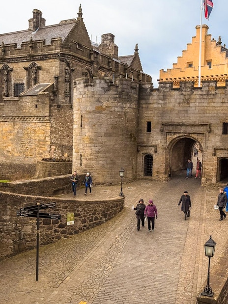 Stirling Castle entrance with visitors walking, part of Loch Lomond, Stirling Castle & The Kelpies Day Tour.