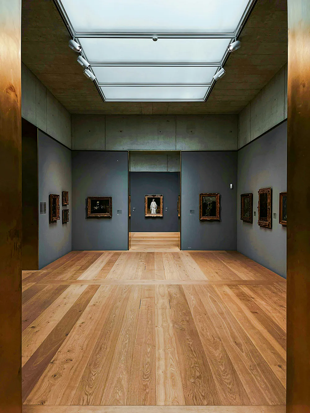 Kunsthaus Zürich museum gallery with wooden floors and framed artworks on gray walls.