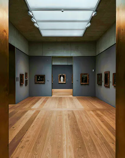 Kunsthaus Zürich museum gallery with wooden floors and framed artworks on gray walls.