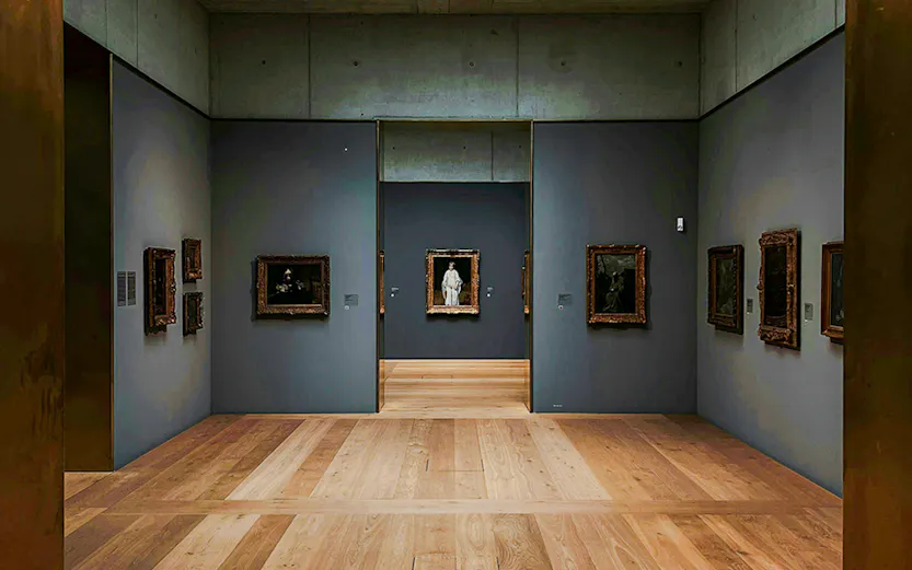 Kunsthaus Zürich museum gallery with wooden floors and framed artworks on gray walls.